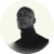 Black and white portrait of a man with glasses wearing a turtleneck, looking upward.